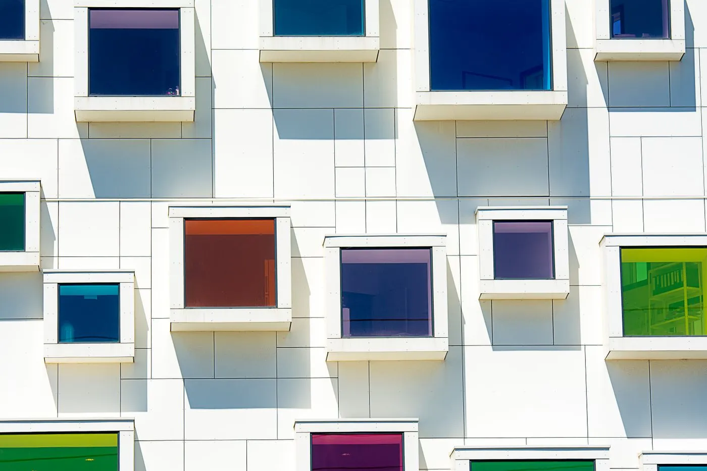 White modern building with vivid red and blue window details